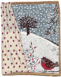 a piece of cloth with a bird on it and snowing trees in the background