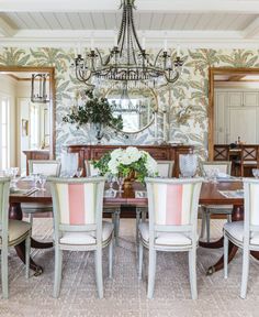 a dining room table with chairs and a chandelier