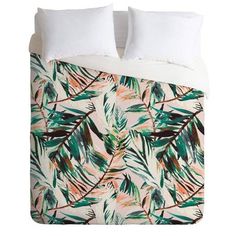 an image of a bed with tropical leaves on it