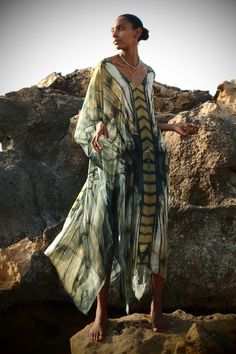 Freya Ashtanga Kaftan, this beautiful v-neck printed caftan in pure silk is cut oversized for an elegant drape and voluminous movement. Featuring a deep v-neckline and adjustable tie at the back. This dress can be transformed from day to night. Wear it as evening wear or as part of your beach outfit. 100% Silk Dry clean Handmade in Ireland FREYA PRINT: A dragonfly inspired print with shiny, iridescent, delicate and intricate wings in an ombre palette of metallics, antique gold, copper, bronze, c Ombre Palette, Silk Cape, Raffia Crochet, Goddess Gown, Athena Goddess, Silk Kaftan, Elegant Drapes, Deep Plunge, Night Wear