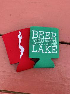 two red and green beer koozies are hanging on the side of a building