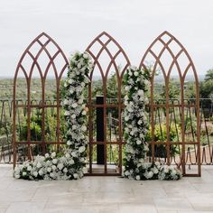 an outdoor ceremony setup with flowers and greenery