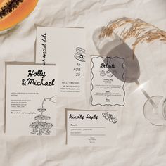 the wedding stationery is laid out on paper