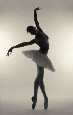 a ballerina in black and white poses for the camera