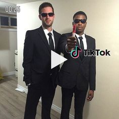 two men in suits and sunglasses are posing for the camera while holding a toothbrush