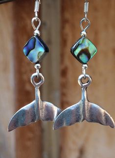 Abalone shell silver whales tail Boho beach earrings. These hand cast whales tail earrings have lots of detail and richness. They are Sterling silver over pewter hand cast with abalone shell beads. They look fabulous on everyone! Very light weight! Ear wires are sterling silver. These earrings are 2 inches long and 1 inch wide across the tail. All my jewelry comes gift boxed with a custom Shelly Mariposa Design butterfly card ready for gift giving, whether it is a gift for you or someone special Handmade Shell-shaped Ocean-inspired Jewelry, Handmade Ocean-inspired Shell-shaped Jewelry, Ocean-inspired Metal Jewelry, Silver Ocean-inspired Earrings For Gifts, Adjustable Dangle Jewelry With Fish Hook, Nickel Free Adjustable Shell-shaped Earrings, Handmade Mermaid Jewelry For Beach, Nickel-free Adjustable Shell-shaped Earrings, Handmade Mermaid Beach Jewelry