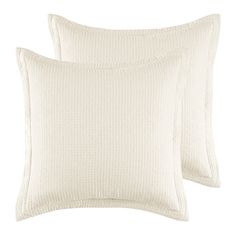 two white pillows sitting next to each other