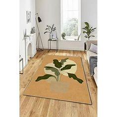 a living room area with hardwood floors and white walls, including a rug that has a potted plant on it