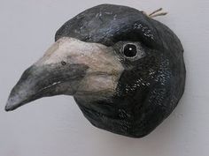 a black and white bird head mounted to the side of a wall