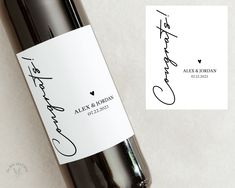 a bottle of wine with a handwritten label next to it on a white surface