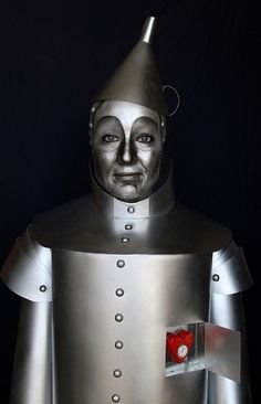 a man in a metal suit with a red heart on his chest