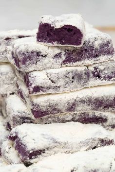 blueberry shortbreads stacked on top of each other with powdered sugar in the middle