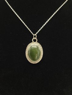 Beautiful Jade cabochon in a Sterling Silver setting.  Jade is fairly translucent, measuring 1 1/2 cm long  x just over 1 cm tall.  Pendant is on a 20" fine Italian Sterling Silver chain. Oval Jade Necklaces With Hallmark, Hallmarked Oval Jade Necklaces, Oval Jade Cabochon Necklaces, Oval Jade Cabochon Necklace, Jade Cabochon Oval Pendant Necklace, Elegant Jade Cabochon Necklace, Jade Cabochon Round Pendant Necklace, Round Jade Cabochon Pendant Necklace, Formal Engraved Necklace With Oval Cabochon