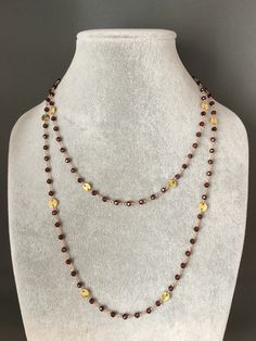 "A true labor of love! Gorgeous sparkling faceted round Red Garnet stones are meticulously wire wrapped with 14k gold filled wire and are combined with brushed 14k gold vermeil round disc links to create this elegant piece. It can be worn as one long chain or doubled to be worn as two. This necklace is finished with a 24k gold vermeil hook and eye clasp and a 24k gold vermeil heart charm. Length can be customized. A pair of matching earrings completes the set. Faceted Red Garnet round stones are Garnet Necklace Gold, Red Gemstone Necklace, Red Garnet Necklace, Flower Earrings Gold, Wire Wrapped Chain, Baroque Pearl Necklace, Garnet Necklace, Necklace Red, Long Chain Necklace