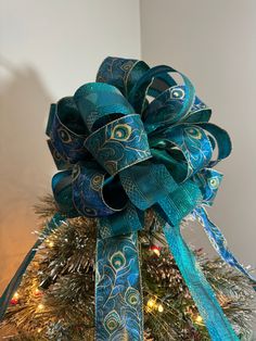 a christmas tree decorated with blue and green ribbons