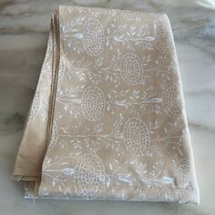 two folded napkins sitting on top of a marble counter