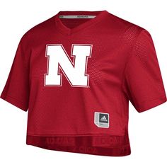 Celebrate your unwavering Nebraska Huskers spirit with the women's adidas red Nebraska Huskers Primegreen V-neck cropped jersey. Crafted from recycled polyester, this jersey features mesh fabric for breathability and screen-printed graphics that proudly display your Nebraska Huskers pride. Its cropped design and V-neck offer a stylish and comfortable fit, perfect for cheering on the Huskers at the stadium or showing your support wherever you go. Primegreen is a series of high-performance materia Nebraska Huskers, Crop Top Designs, Red Adidas, Mesh Fabric, Nebraska, Adidas Women, Comfort Fit, Nordstrom, Tops Designs