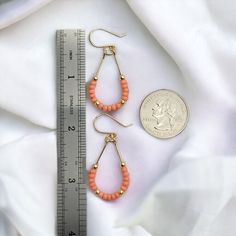 Make a statement with Lane - Gold & Coral! These 14k Gold filled teardrop hoop earrings featuring Peach coral seed beads will guarantee you some serious style points. Perfect for a fun summer night out! Approximately 1.75” long Made with 14k Gold Filled wire Glass Miyuki Seed Beads Polished to a high shine Handmade in Montana Sent in a ribboned gift box with polishing cloth Spring Teardrop Jewelry, Beaded Teardrop Earrings For Summer, Summer Beaded Teardrop Earrings, Wire Wrapped Teardrop Hoop Earrings, Summer Teardrop Beaded Earrings, Trendy Teardrop Jewelry For Spring, Spring Teardrop Earrings, Spring Trendy Teardrop Jewelry, Nickel Free Teardrop Earrings For Summer