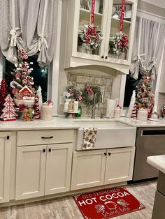 a kitchen decorated for christmas with red and white decor