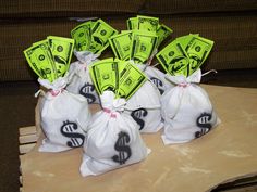 several bags filled with money sitting on top of a wooden table next to a couch