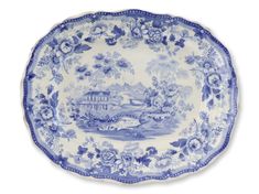 a blue and white plate with an image of a house in the middle of it