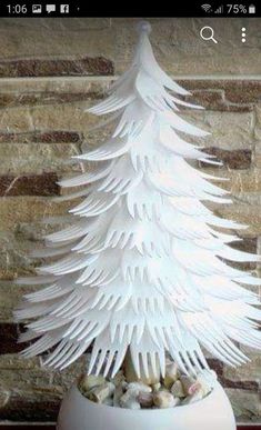 a white christmas tree sitting on top of a table