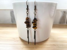 "These earrings are made with gorgeous amber coloured Tiger's Eye beads and antique bronze chain and findings. All metal materials are nickel and lead free. Measurements: approx. 2.25\"L in length. Earrings are shipped in a ready to give box. Personalized messages are welcomed. Check out my handmade pillow covers, pouches and embroidery hoop art in my other shop: www.etsy.com/shop/BlackcatmeowDesigns" Give Box, Amber Citrine Dangle Jewelry, Brown Multi-strand Jewelry With Dangling Beads, Tiger Eye Earrings Jewelry, Amber Citrine Dangle Earrings, Tiger Eye Necklace Handmade, Amber Gemstone, Handmade Pillow Covers, Tiger Eye Beads