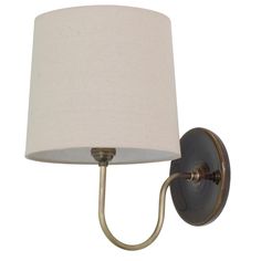 a wall light with a white shade on the side and a metal arm that is attached to it