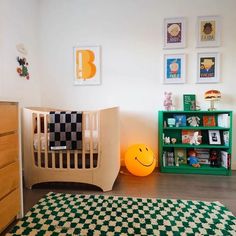 a child's room with green and white checkered rugs on the floor