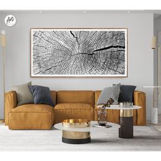 a living room with a couch, coffee table and large art piece on the wall