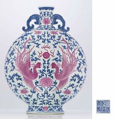 a blue and white vase with two birds on it