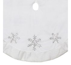 a white snowflake tablecloth with silver sequins on the top and bottom