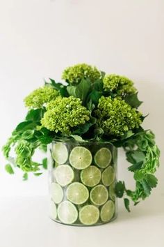 a vase filled with lots of green vegetables