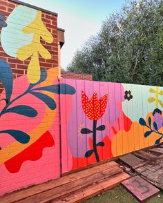 a colorful fence painted with flowers on it