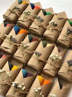 a bunch of brown paper wrapped in twine with flowers on them