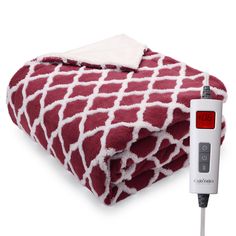 a blanket with a thermometer on it next to an electric heated blanket that is red and white