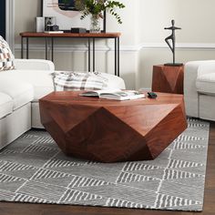 a living room with white couches and wooden tables