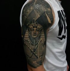 a man with a tattoo on his arm has an image of the egyptian god tutan