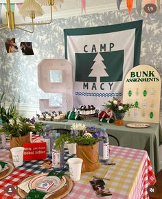 the table is set up for an outdoor camping party with bunting banners and decorations