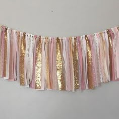 a pink, gold and white banner hanging from the wall