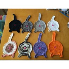 six crocheted bunnies sitting on top of a wooden table next to each other