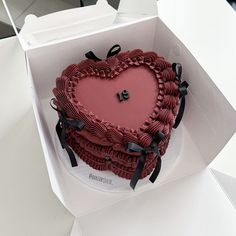 a heart shaped cake in a white box