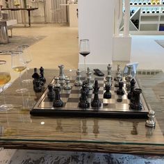 a chess board with wine glasses on it