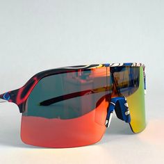 a pair of sunglasses with red, yellow and blue mirrored lenses on top of it