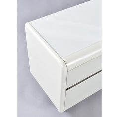 a close up of a white drawer on a gray surface with no one around it