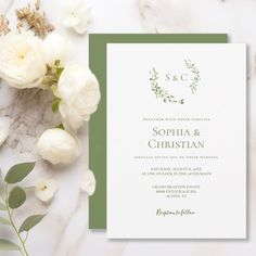 wedding stationery with white flowers and greenery on marble background, close up view