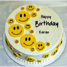 a happy birthday cake with smiley faces on it