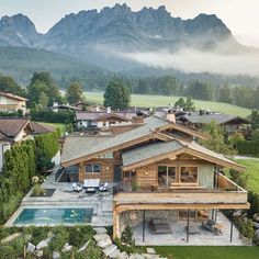 an aerial view of a house with mountains in the background