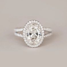 an oval cut diamond ring with double halos