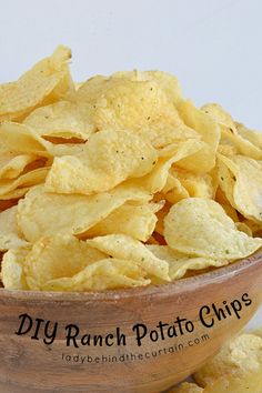 a wooden bowl filled with potato chips